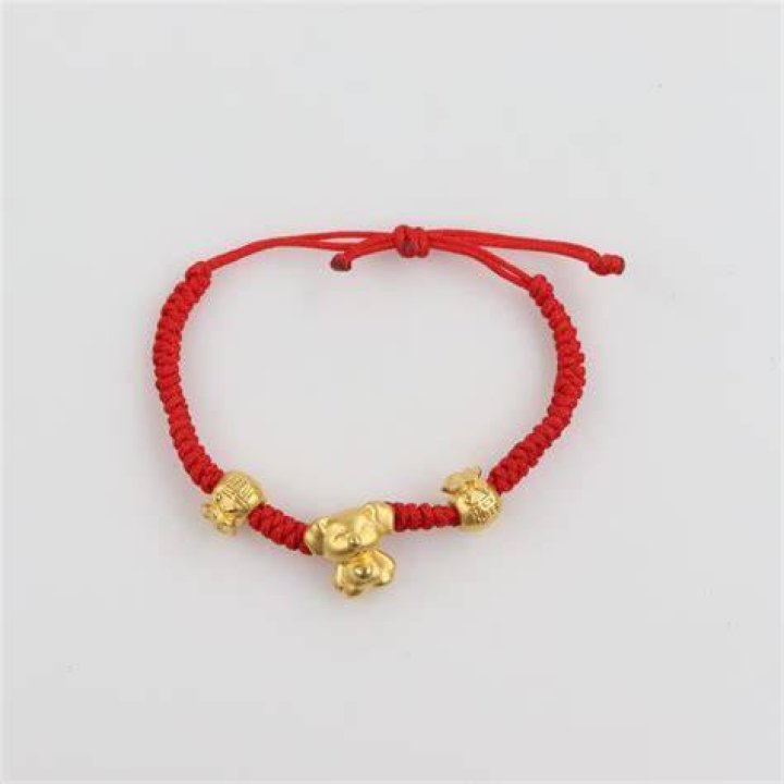 Red Bracelet with Gold Accents Worn by Alison Oliver as Catton